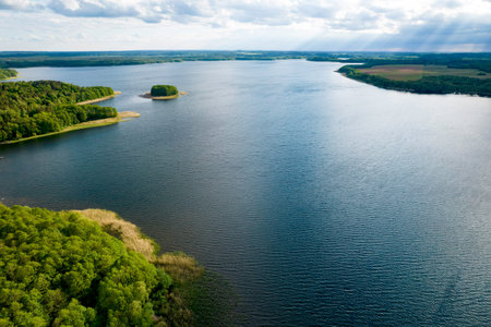 View from the top of Wierzchowo lake in Poland. Green forest surrounding the lake and clear blue...