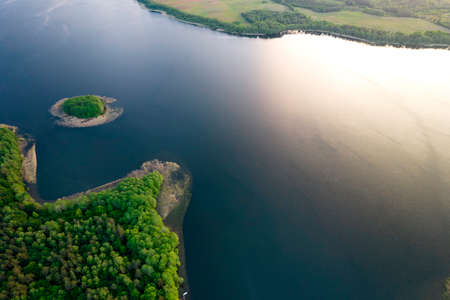 View from the top of Wierzchowo lake in Poland. Green forest surrounding the lake and clear blue water Rural landscape in Poland.の写真素材