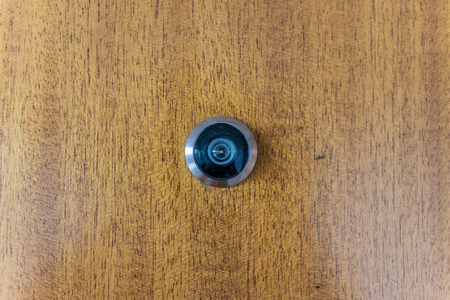 Peephole Wooden Door Metal Rim Circular Security Textureの写真素材