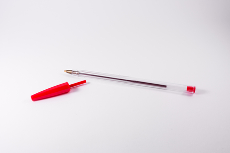 Red Pen Tip Cap Tube Plastic Clear Office Supply White Background Closeupの写真素材