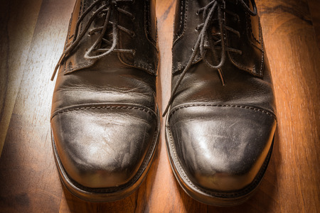 Black Leather Dress Shoes Worn Wooden Floor Sunlight Spotlight Sheen Elegenat Business Casualの写真素材