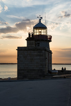 Warm Blue Orange Sunset Sky over Howth Lighthouse Tower Irelandの写真素材