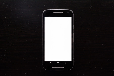 Blank White Screen Frame Cell Phone Android Black Wood Deskの写真素材