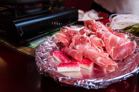Aluminum Foil Plate Bowl Raw Meat Beef Pieces Collection Chinese Hot Pot Sharing Food Eating Restaurant Table Red White Detail Closeupの写真素材