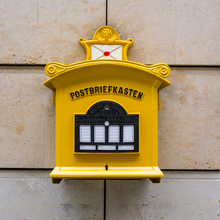 Yellow Metal Old Mailbox Stone Wall Traditional 1800 German Dresden European Bright Colorの写真素材