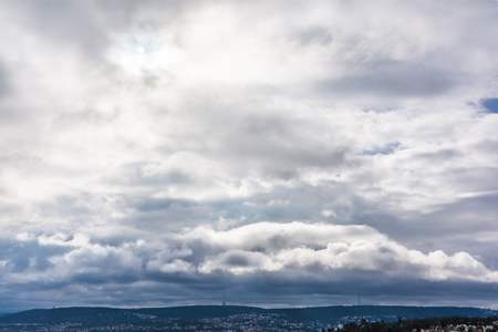 Dramatic Sky Over City Hills Clear Clouds Dark Stormy Sun Bright Shadows Fluffy Blue Emotion Moodの写真素材