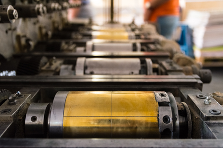 Golden Letterpress Cylinders Rustic Vintage Printing Method Metallic Rollers Four Color CMYK Print Closeup Machine Industrial Equipmentの写真素材