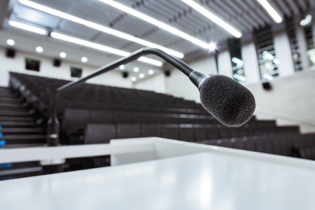 Microphone on Podium Stand in Large University Lecture Hall Auditorium White Modern Education Instituteのeditorial素材