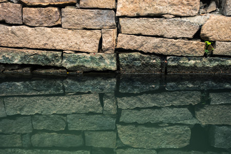 Bricks on Waterside and its Inverted Reflection in Waterの写真素材