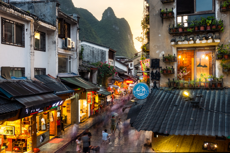 YANGSHUO, CHINA AUGUST 2018: Yangshuo Western Street Busy at Sunset Bustling with Peopleのeditorial素材