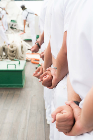Sailors in Line with Hands Behind Backs Attention White Uniforms Maleの写真素材