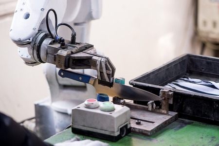 Robot arm manufacturing sanding knife blade closeupの写真素材