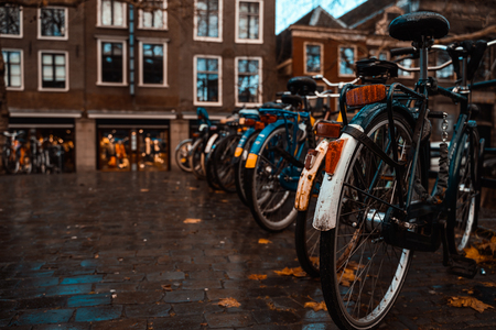 Bikes on a Bridge in Amsterdam, Netherlands Wet Overcast Weather Vacation Destination Transportationの写真素材
