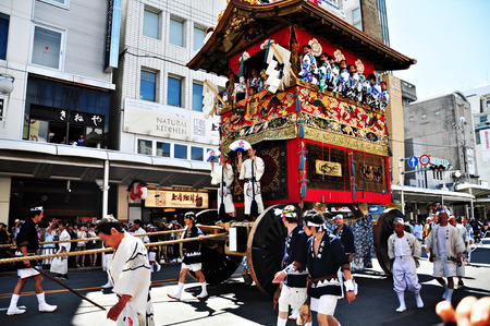 KYOTO, JAPAN: A highly decorated float along with its accompanying men in traditional Japanese clothes is being dragged in a parade during the Gion Matsuri of July, 17th 2011 in Kyoto, Japan.のeditorial素材