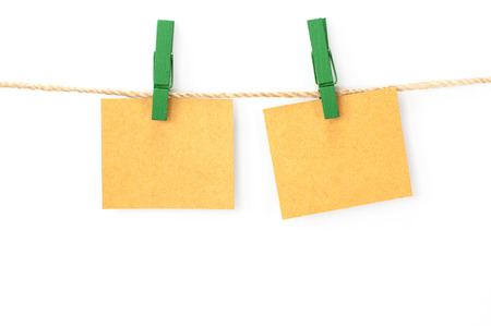 Notice card, brown paper and wood clips on white backgroundの写真素材