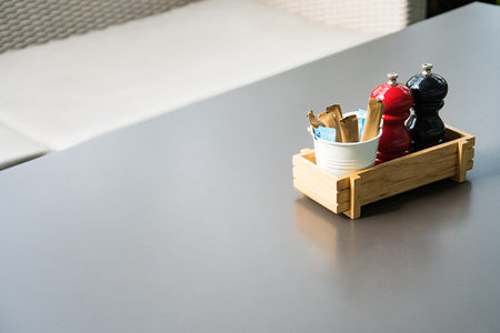 Salt and paper shakers with creamer and sugar sachetsの写真素材
