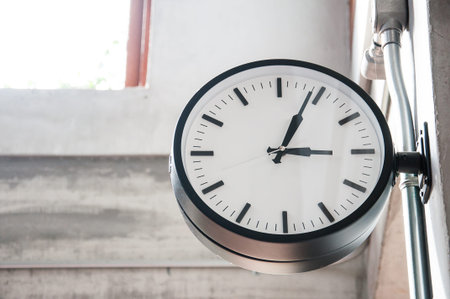 Standard clock hanging from the concrete wall
