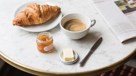 Breakfast with coffee, croissant and butterle tableの素材