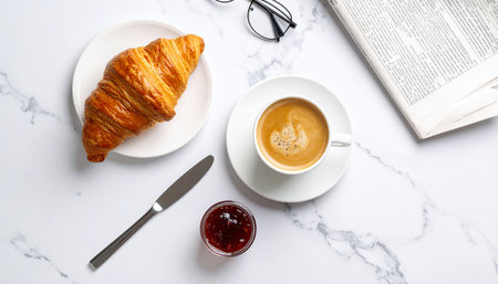 Breakfast with coffee and croissant on a white marble tableの素材