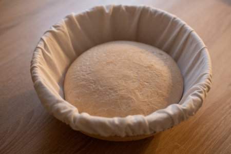 The process of raising the dough in a special basket. Dough made from natural sourdough. Wheat dough. Fermentation.の写真素材
