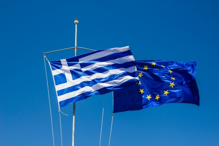 Greek and EU Flags versus the blue skyの写真素材