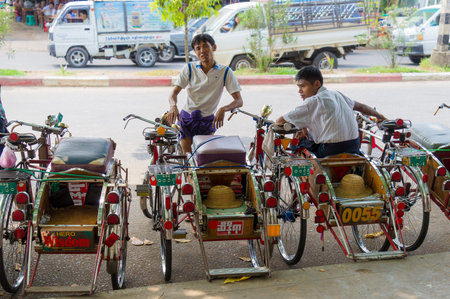 YANGON, MYANMAR - MAR 5: Trishaws drivers taking rest and waiting for guest in Yangon, on Mar 5,...
