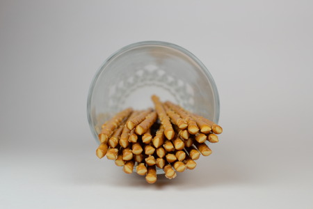Baked small sticks in glass on white backgroungの写真素材