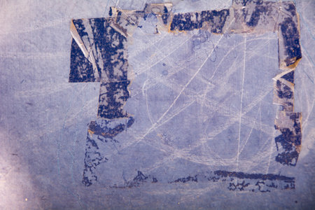 Scratched violet metal plate with cut off glue tapeの写真素材