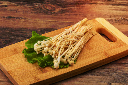 Raw Japanese Enoki mushrooms for cookingの写真素材