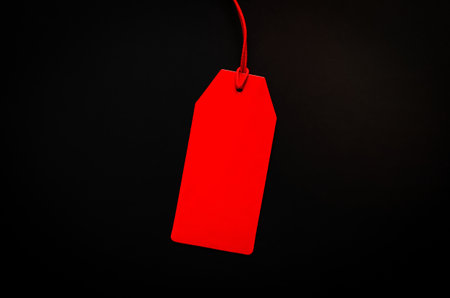 A red blank price tag on black background for shopping and discount on Black Friday concept.の写真素材