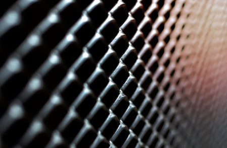 The photo with focus and blurred of dark gray and silver grid of metal fence that taking as background.の写真素材