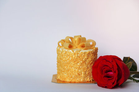 The butter cake and fresh red color rose that give for birthday present isolated on white backgroundの写真素材