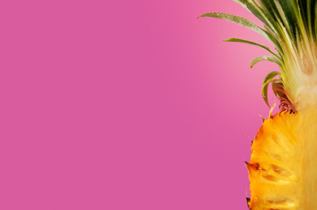 The fresh slice of yellow color pineapple fruit isolated on pink background for summer season with space for text.の写真素材