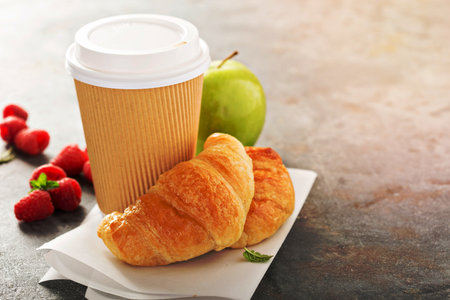 Coffee to go with croissants and apple with copy spaceの写真素材