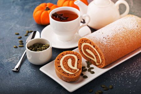 Fall dessert pumpkin roll with cream cheese frostingの写真素材