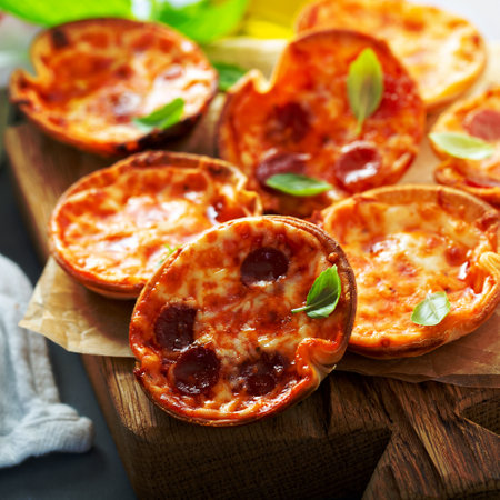 Mini pepperoni and cheese pizzas with tomato sauce and mozzarella cheeseの写真素材
