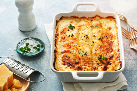 Cheesy scalloped potatoes with thyme and parmesanの写真素材