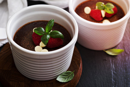 Chocolate pots de creme dessert in ramekins with raspberriesの写真素材
