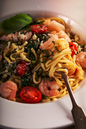 Fresh pasta linguine with shrimp and tomatoes, capers and basilの写真素材
