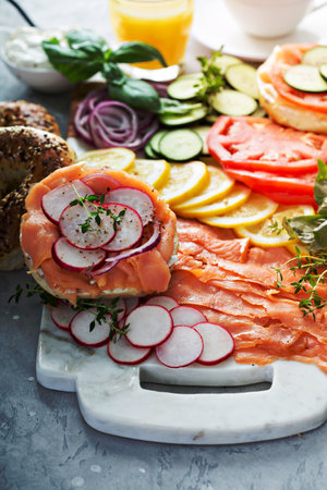 Bagels and lox platter for breakfast with vegetables and cream cheeseの写真素材