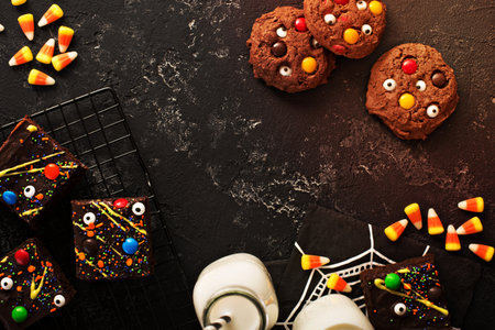 Chocolate monster brownies with candy and sprinkles, homemade treats for Halloween overhead shot with copyspaceの写真素材