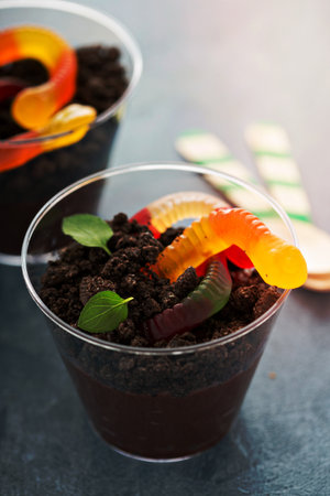 Children chocolate pudding dessert in a cup called dirt and wormsの写真素材