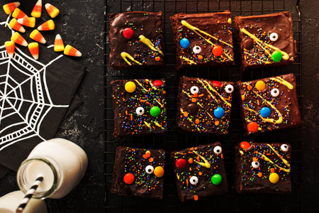 Chocolate monster brownies with candy and sprinkles, homemade treats for Halloween overhead shotの写真素材