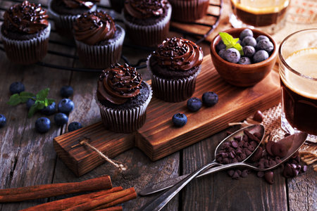 Coffee and chocolate cupcakes on wooden tableの写真素材