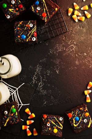 Chocolate monster brownies with candy and sprinkles, homemade treats for Halloween overhead shot with copyspaceの写真素材