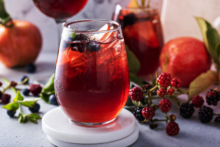 Fall berry and apple sangria in a glass with ice, refreshing fall cocktail or mocktail ideaの写真素材