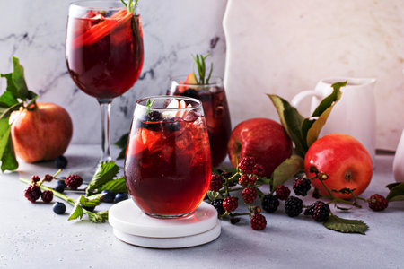 Fall berry and apple sangria in a glass with ice, refreshing fall cocktail or mocktail ideaの写真素材