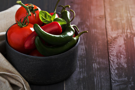 Green and red hot pepper in a bowlの写真素材