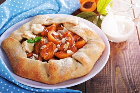 Free form open pie with apricots and almondsの写真素材