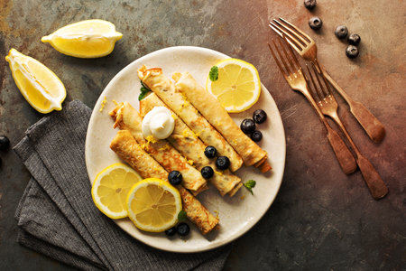 Crepes with lemon filling and fresh blueberriesの写真素材